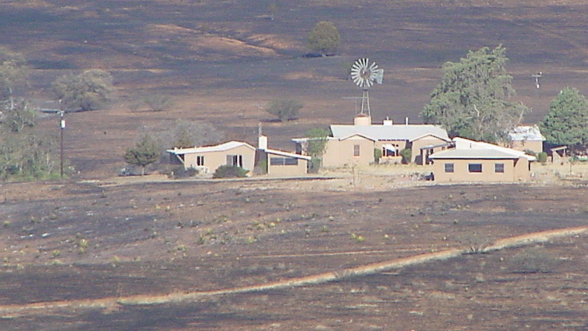 Ranch completely surrounded by burned land